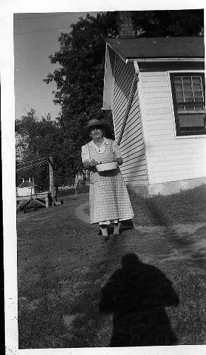 Elizabeth (Schlenk) Rettler standing in the back of her home - circa early 1950's