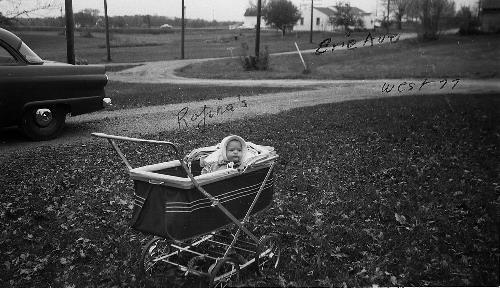 Susan Rojina in baby carriage - October 1957