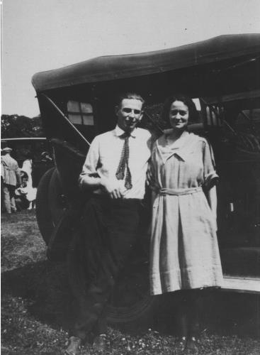Joe and Susan Meuwissen standing by the side of their auto - circa 1920