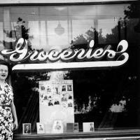Rita Rojina with her WWII  photo display in Pauly's store front window - 1945